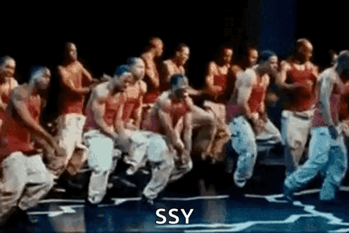 A Group Of Men Are Dancing On A Stage With The Words Ssy Written On The Bottom Of The Image . GIF
