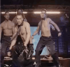 A Group Of Men Are Dancing On A Stage Without Shirts On . GIF
