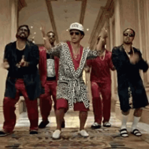 A Group Of Men Are Dancing Together In A Hallway . One Of The Men Is Wearing A Bathrobe . GIF