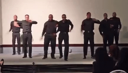 A Group Of Men Are Dancing Together On A Stage GIF