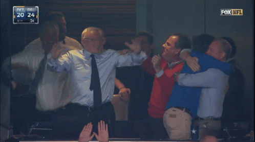 A Group Of Men Are Hugging Each Other In A Fox Nfl Game GIF
