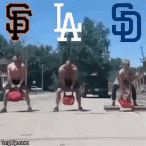 A Group Of Men Are Lifting Weights On A Street In Front Of A San Diego Padres Logo . GIF