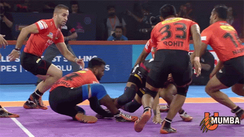 A Group Of Men Are Playing A Game Of Kabaddi And One Of Them Has The Number 33 On His Back GIF