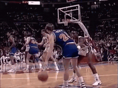 A Group Of Men Are Playing Basketball On A Court . GIF
