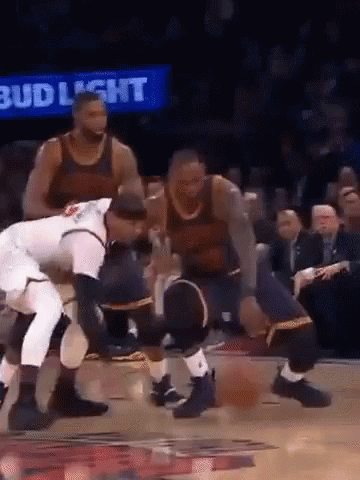 A Group Of Men Are Playing Basketball On A Court With A Bud Light Sign Behind Them . GIF