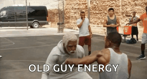 a group of men are playing basketball on a court with the words old guy energy written on the bottom