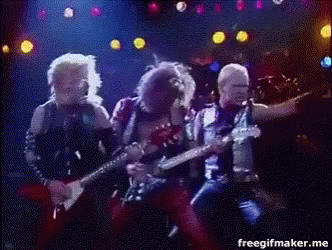A Group Of Men Are Playing Guitars And Singing On A Stage In Front Of A Crowd . GIF