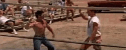 A Group Of Men Are Playing Volleyball On A Beach With A Volleyball Net In The Background . GIF