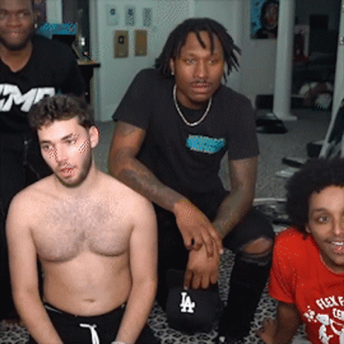 A Group Of Men Are Posing For A Picture And One Of Them Has A La Hat On GIF