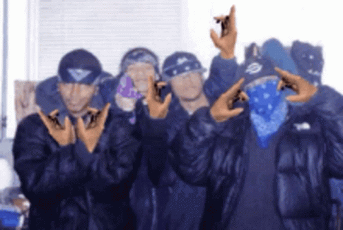 A Group Of Men Are Posing For A Picture And One Of Them Is Wearing A Bandana GIF
