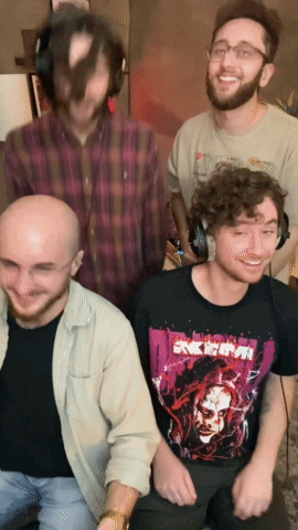 A Group Of Men Are Posing For A Picture And One Of Them Is Wearing A Shirt That Says " Akira " On It GIF