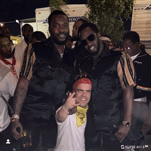 A Group Of Men Are Posing For A Picture With A Truck In The Background That Says ' King A.i.s ' GIF