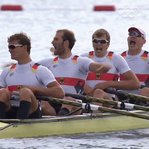 A Group Of Men Are Rowing A Boat And One Of Them Is Wearing A Shirt That Says Germany GIF