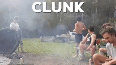 A Group Of Men Are Sitting Around A Campfire With The Word Clunk Written Above Them GIF