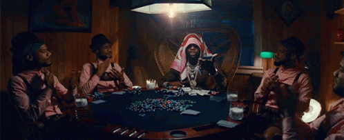 A Group Of Men Are Sitting Around A Poker Table Playing Cards GIF