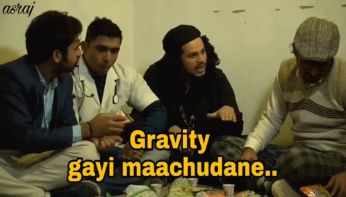 A Group Of Men Are Sitting Around A Table With A Caption That Says Gravity Gayi Maachudane GIF