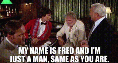 A Group Of Men Are Sitting At A Table In A Bar And Talking . GIF