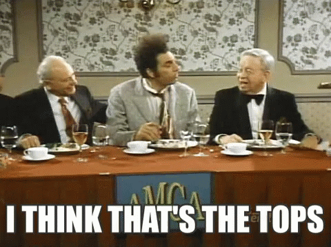 A Group Of Men Are Sitting At A Table With A Sign That Says I Think That 'S The Tops On It . GIF