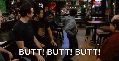 A Group Of Men Are Sitting At Tables In A Bar And A Man Is Dancing . GIF