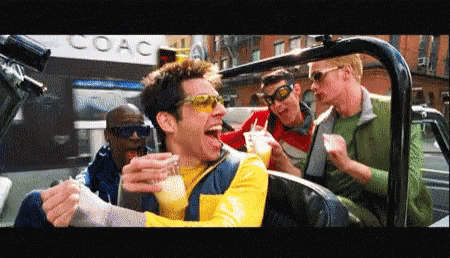 A Group Of Men Are Sitting In A Car In Front Of A Coach Building GIF