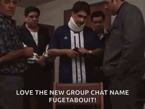 A Group Of Men Are Standing Around A Man Wearing A Neck Brace And A Shirt That Says Adidas GIF