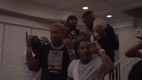 A Group Of Men Are Standing Around Each Other Holding Money . GIF