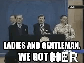 A Group Of Men Are Standing Behind A Podium Giving A Speech . GIF