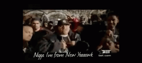 A Group Of Men Are Standing In A Crowd And One Of Them Is Wearing A Hat That Says Ny On It . GIF