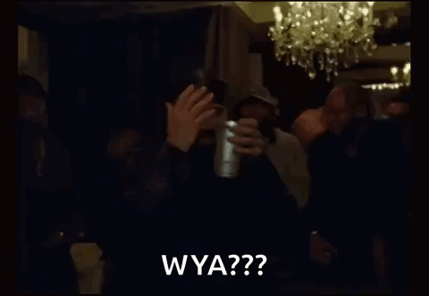 A Group Of Men Are Standing In A Dark Room Holding A Cup And Clapping . GIF