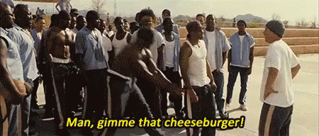 A Group Of Men Are Standing In A Line And One Of Them Says Man Gimme That Cheeseburger . GIF