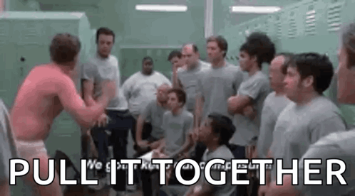 A Group Of Men Are Standing In A Locker Room And One Of Them Is Wrestling Another Man . GIF