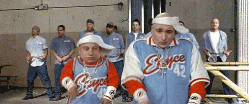A Group Of Men Are Standing In A Room And One Of Them Is Wearing A Jersey That Says Skyce 42 GIF