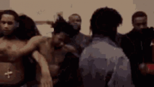 A Group Of Men Are Standing In A Room Without Shirts On GIF