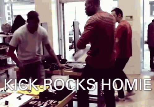 a group of men are standing in a store with the words kick rocks homie on the bottom