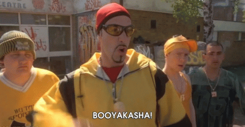 A Group Of Men Are Standing In Front Of A Building And One Of Them Is Saying Booyakasha GIF