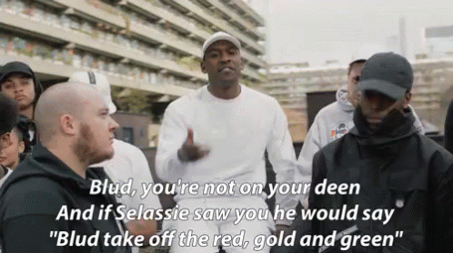 A Group Of Men Are Standing In Front Of A Building And One Of Them Says Blud You 'Re Not On Your Deen . GIF