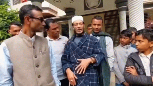 A Group Of Men Are Standing In Front Of A Building . GIF