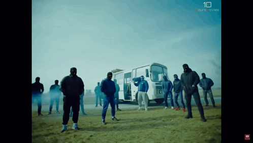 A Group Of Men Are Standing In Front Of A Bus With The Number 10 On The Bottom Right GIF