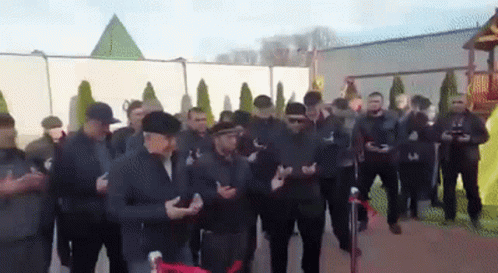 Men Standing In Front Of Pyramid GIF
