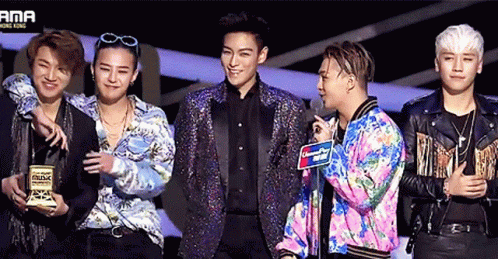A Group Of Men Are Standing In Front Of A Sign That Says Ama Hong Kong GIF