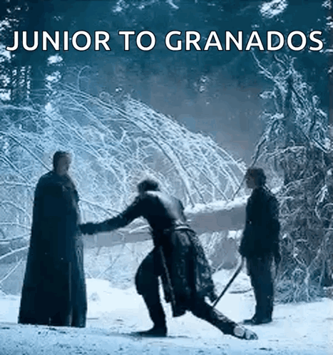 A Group Of Men Are Standing In The Snow With The Words Junior To Granados Above Them GIF