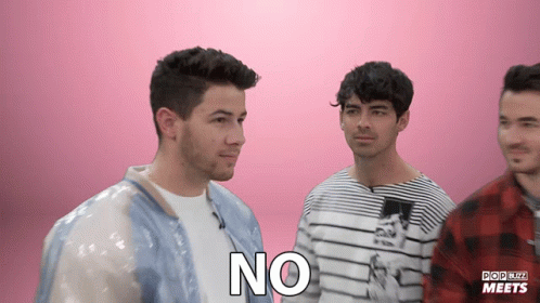 A Group Of Men Are Standing Next To Each Other And One Of Them Has The Word No On His Chest GIF