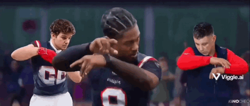 A Group Of Men Are Standing Next To Each Other And One Of Them Is Pointing At The Camera GIF