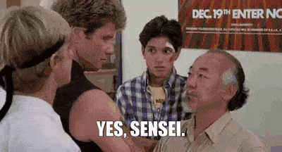A Group Of Men Are Standing Next To Each Other And One Of Them Is Talking To Another Man . GIF