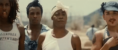 A Group Of Men Are Standing Next To Each Other And One Of Them Is Wearing A Bandana On His Head . GIF
