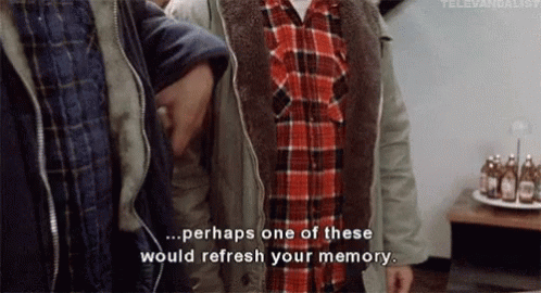 a group of men are standing next to each other and one of them is wearing a plaid shirt and a jacket .