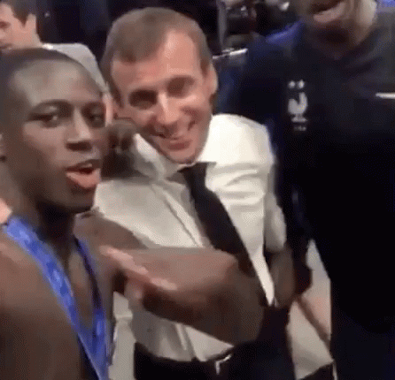 A Group Of Men Are Standing Next To Each Other And Smiling . GIF