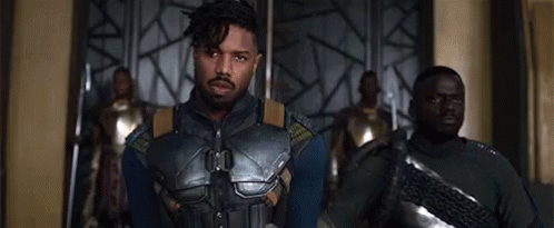 A Group Of Men Are Standing Next To Each Other In A Room And Looking At The Camera . GIF