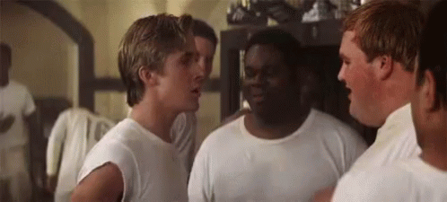 A Group Of Men Are Standing Next To Each Other In A Room And Talking . GIF