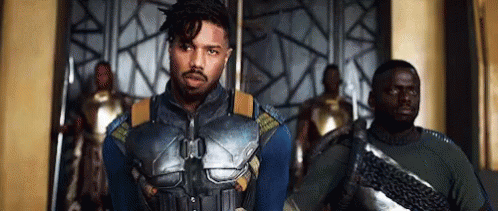 A Group Of Men Are Standing Next To Each Other In A Room . GIF